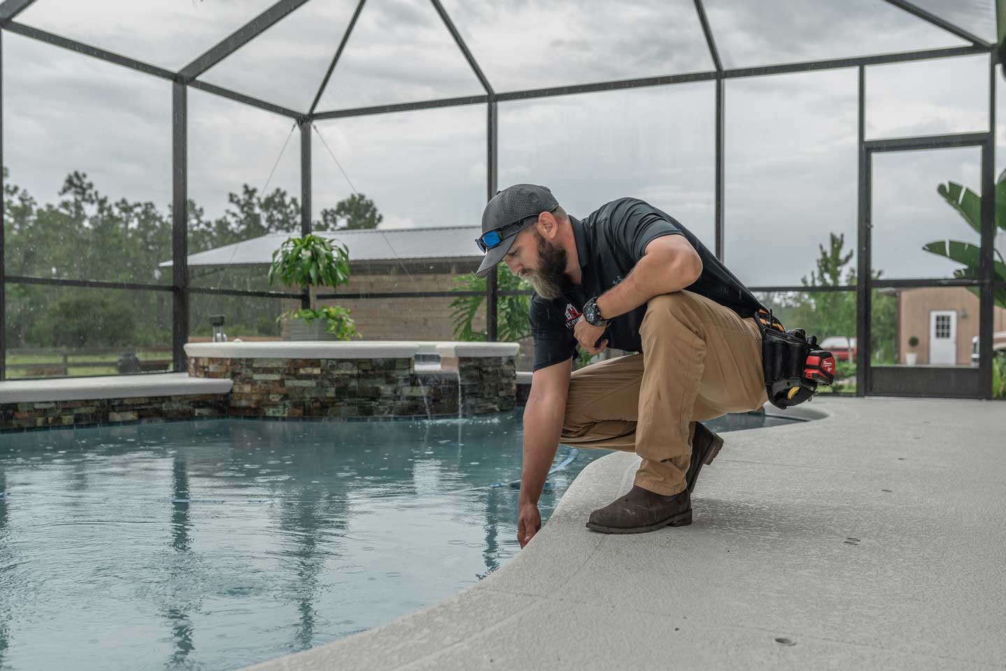 Inspector examining a pool at a home