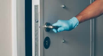 Home inspector inspecting door